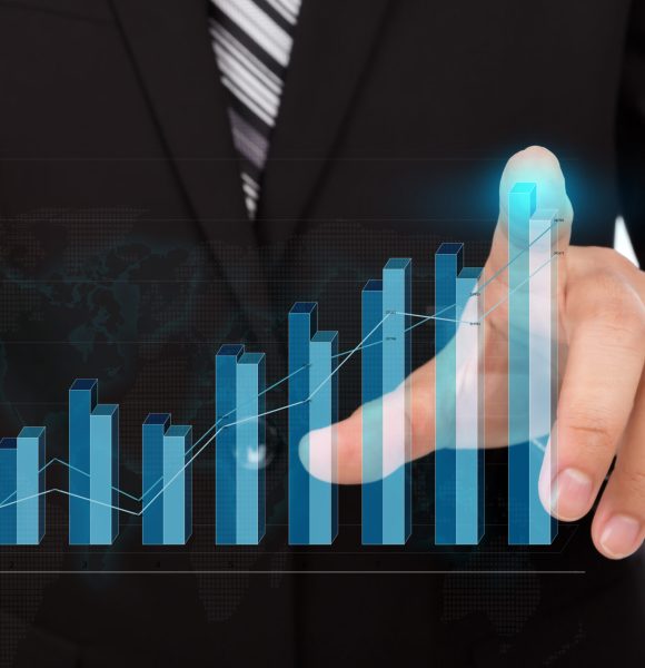 Business man pressing high tech type of modern graph on a virtual background