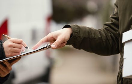 close up signing package delivery