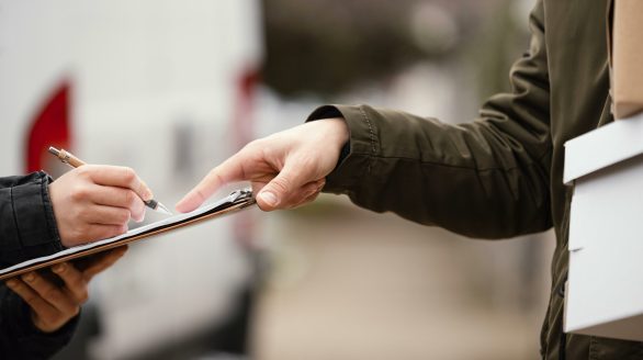 close up signing package delivery